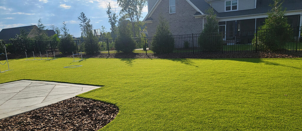 Pet-friendly artificial turf in a South Carolina home, combining comfort and resilience for outdoor pet areas.